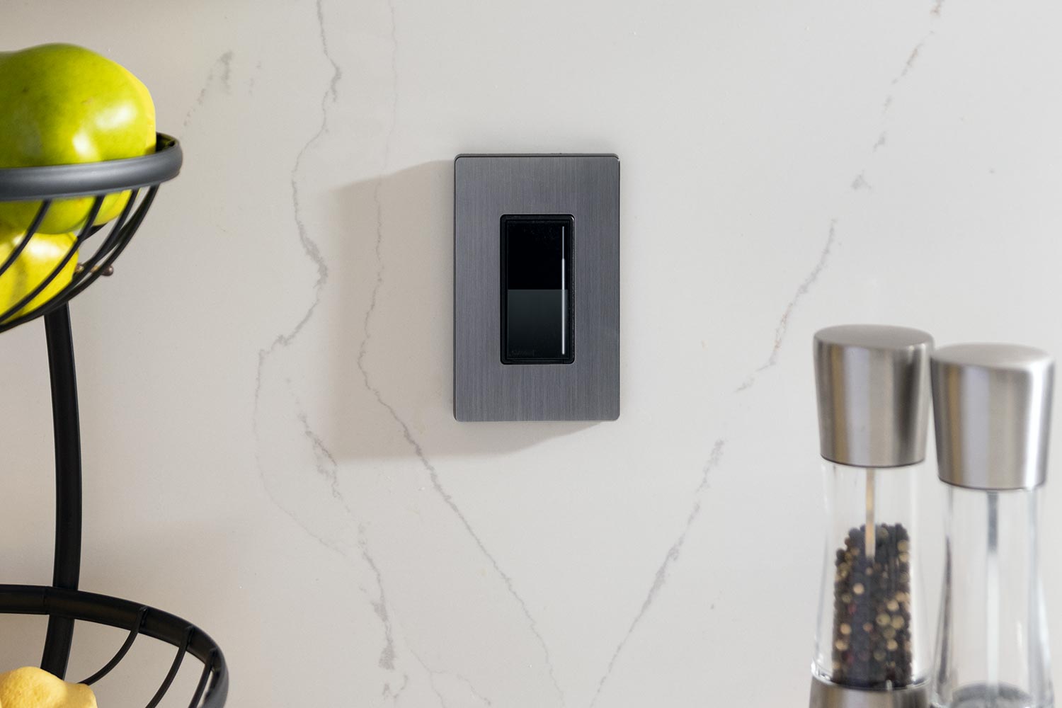 Lutron light keypad in a white marble kitchen