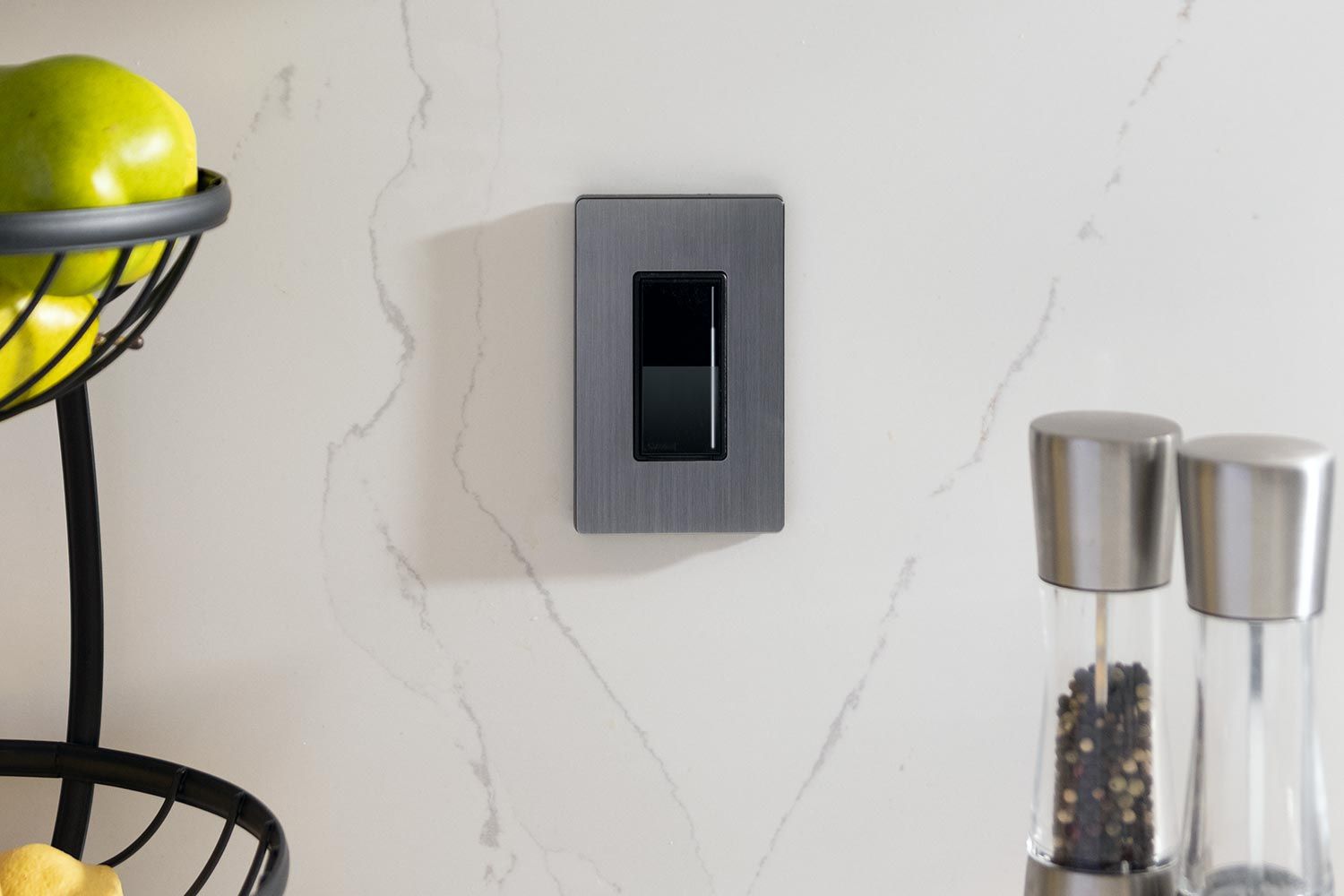 Lutron light keypad in a white marble kitchen
