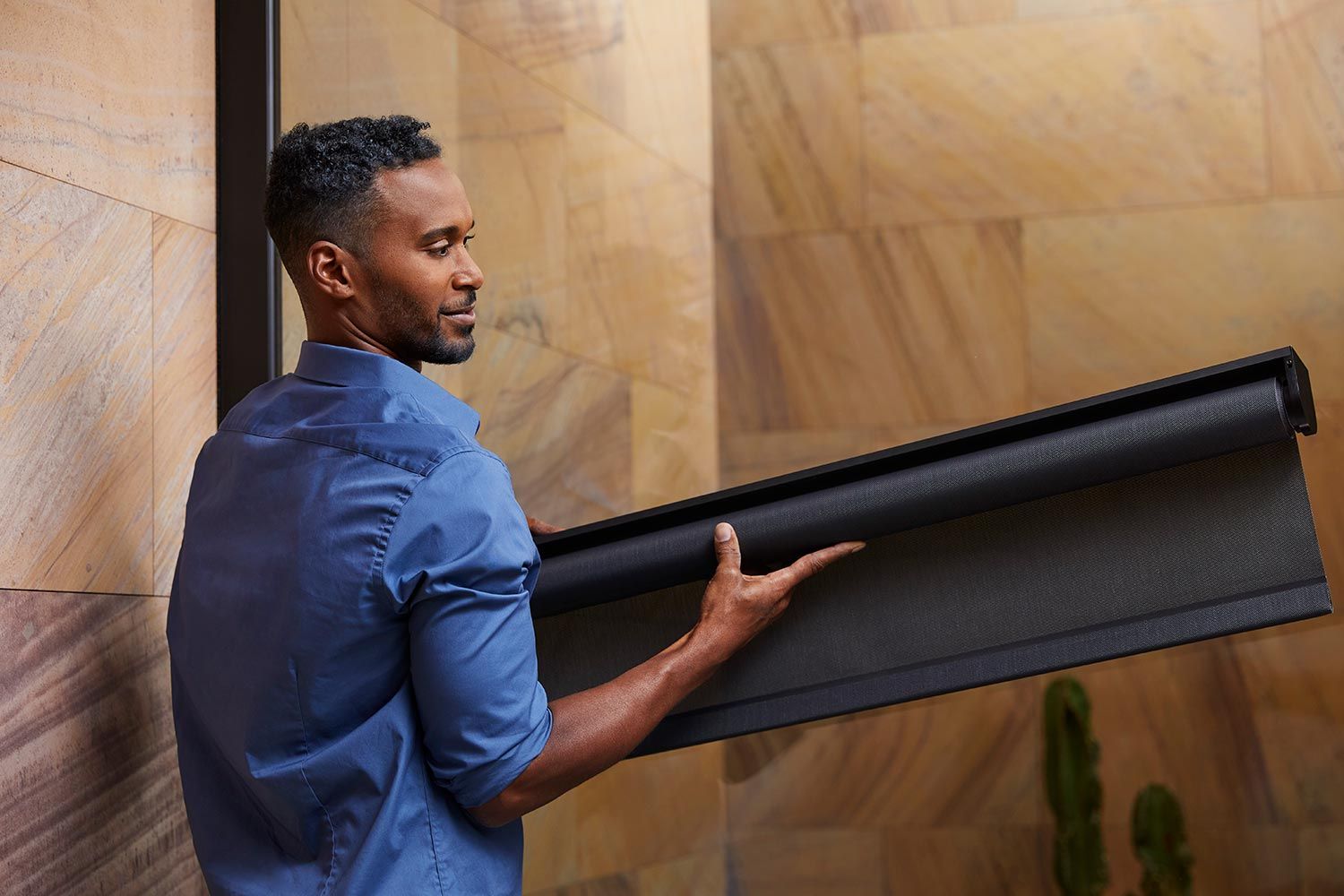 Man installing a black shade